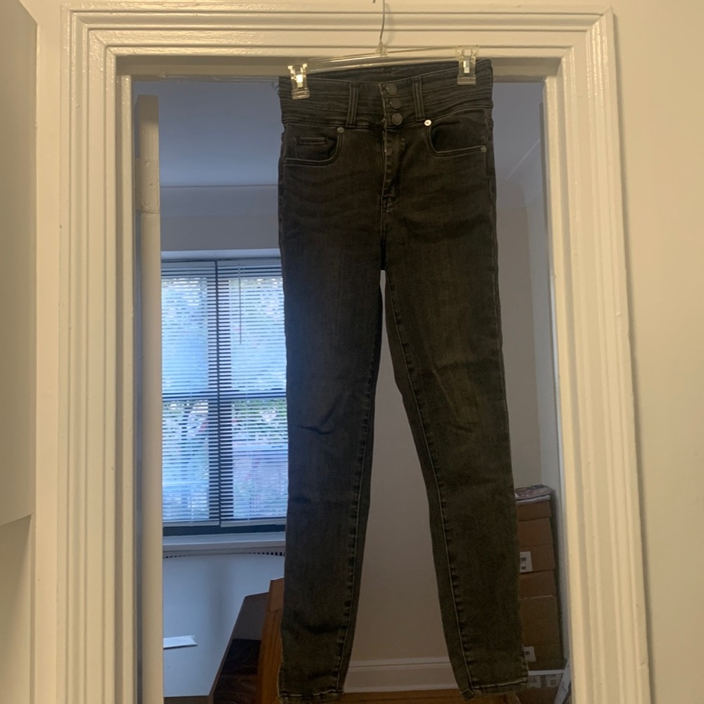 Denim very high waisted jeans.  5 pockets, 2” slit at hem. Slim fit.
